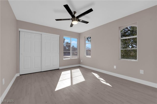 4324 W Lake Mead Blvd Unit 202, Las Vegas, NV 89108 - unfurnished bedroom with light wood-style flooring, baseboards, ceiling fan, and a closet