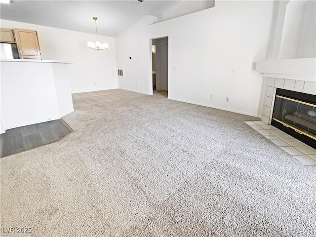 unfurnished living room featuring light colored carpet, a chandelier, a fireplace, vaulted ceiling, and baseboards