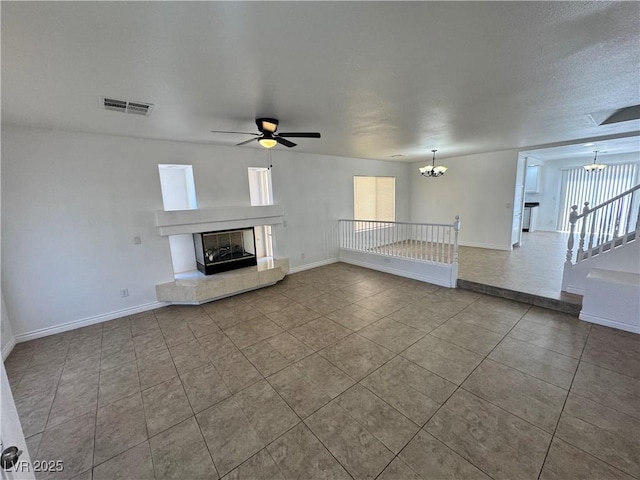 10574 Salmon Leap St, Las Vegas, NV 89183 - unfurnished living room featuring a chandelier, tile patterned flooring, a fireplace with raised hearth, and baseboards