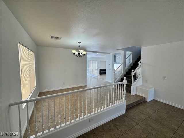10574 Salmon Leap St, Las Vegas, NV 89183 - stairs with a chandelier, baseboards, tile patterned floors, and a textured ceiling