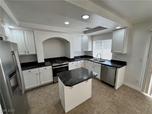 10574 Salmon Leap St, Las Vegas, NV 89183 - kitchen featuring stainless steel appliances, a sink, a textured ceiling, white cabinets, and recessed lighting