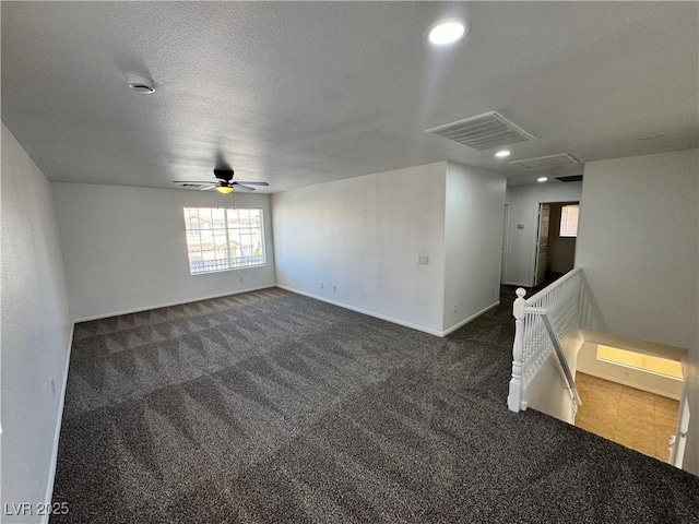 10574 Salmon Leap St, Las Vegas, NV 89183 - unfurnished room with ceiling fan, dark carpet, baseboards, recessed lighting, and a textured ceiling