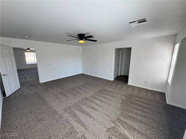 10574 Salmon Leap St, Las Vegas, NV 89183 - spare room with a ceiling fan, dark carpet, and baseboards