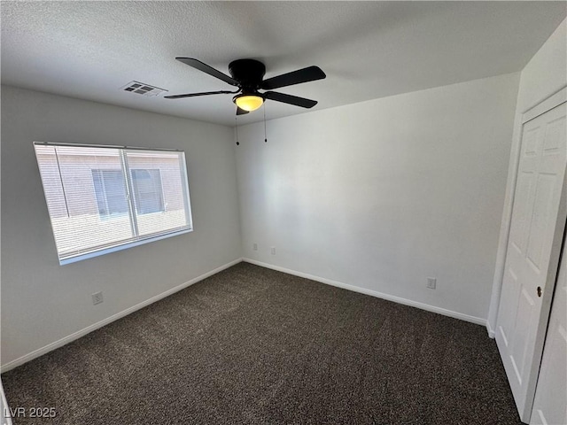 10574 Salmon Leap St, Las Vegas, NV 89183 - empty room featuring ceiling fan, dark carpet, baseboards, and a textured ceiling