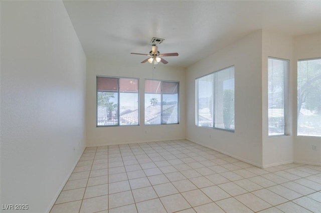 494 Dart Brook Pl, Henderson, NV 89012 - empty room featuring plenty of natural light, ceiling fan, light tile patterned floors, and baseboards