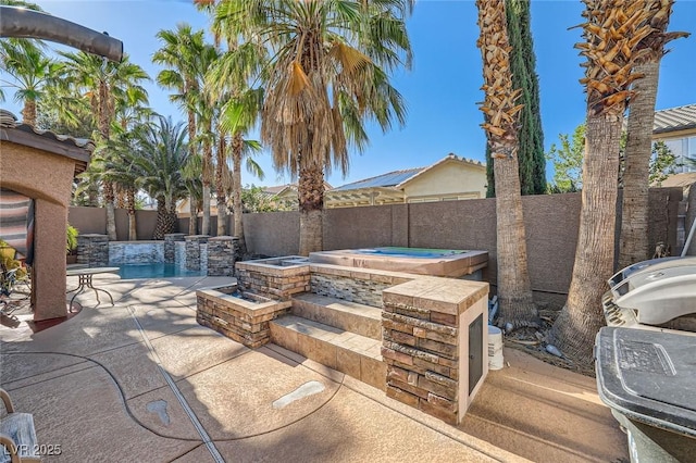 10310 Songsparrow Ct, Las Vegas, NV 89135 - view of patio with an in-ground hot tub and a fenced backyard