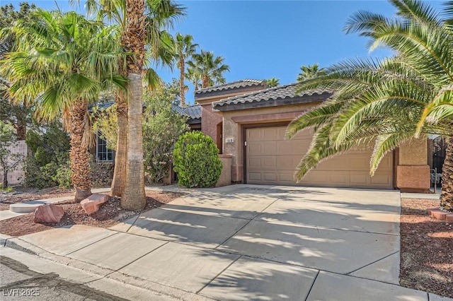 10310 Songsparrow Ct, Las Vegas, NV 89135 - view of front of house with driveway, a tile roof, stucco siding, and a garage