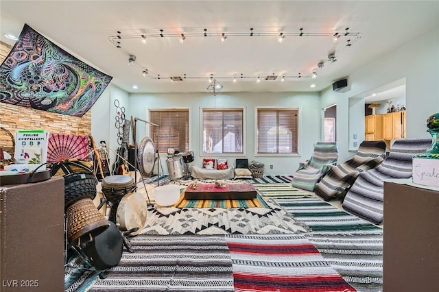 10310 Songsparrow Ct, Las Vegas, NV 89135 - carpeted living area featuring rail lighting and healthy amount of natural light