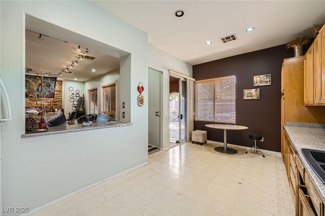 10310 Songsparrow Ct, Las Vegas, NV 89135 - kitchen with rail lighting, light flooring, baseboards, and recessed lighting
