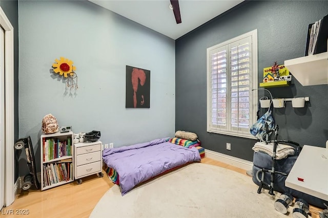 10310 Songsparrow Ct, Las Vegas, NV 89135 - bedroom with wood finished floors, a ceiling fan, and baseboards