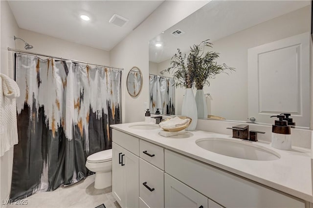full bathroom featuring double vanity, toilet, a shower with curtain, and tile patterned flooring
