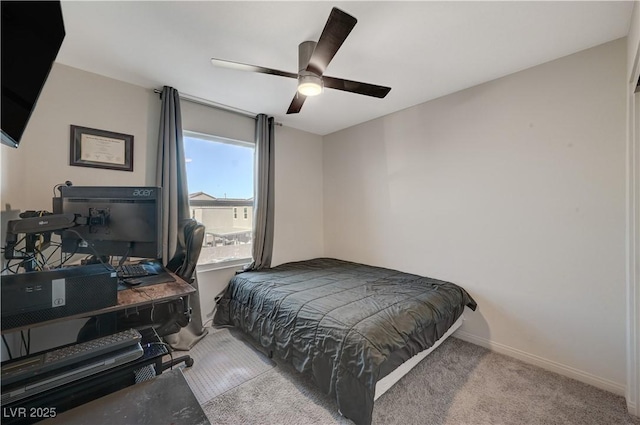 carpeted bedroom featuring baseboards and ceiling fan
