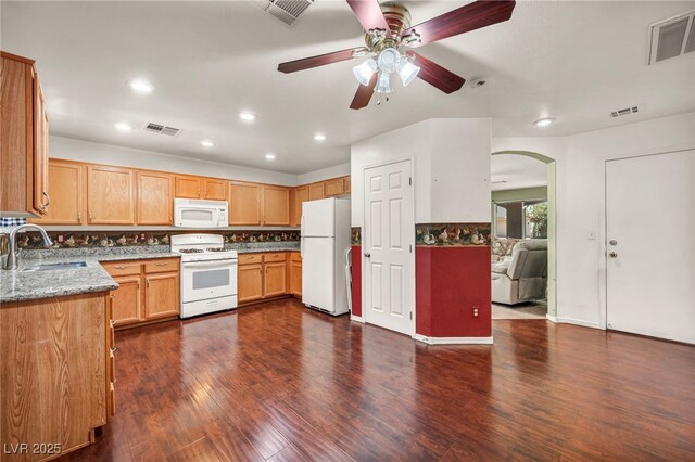9165 Starling Wing Pl, Las Vegas, NV 89143 - kitchen with white appliances, a sink, light stone countertops, recessed lighting, and backsplash