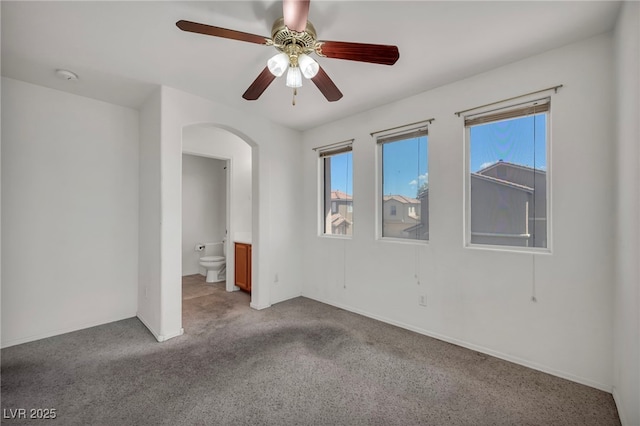 9165 Starling Wing Pl, Las Vegas, NV 89143 - unfurnished room with arched walkways, healthy amount of natural light, ceiling fan, and light colored carpet