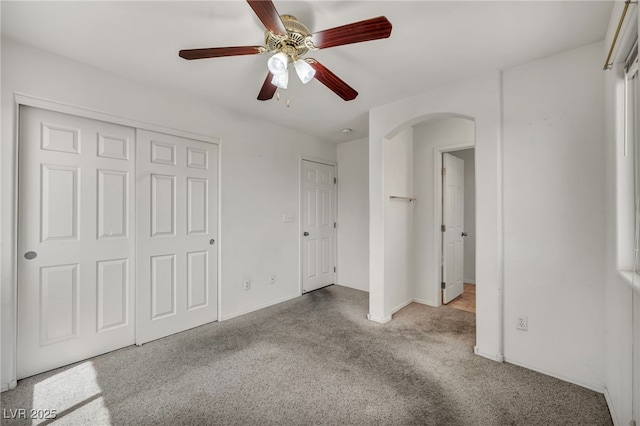9165 Starling Wing Pl, Las Vegas, NV 89143 - unfurnished bedroom featuring carpet, arched walkways, baseboards, and ceiling fan