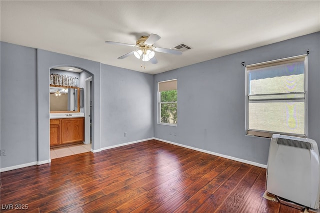 9165 Starling Wing Pl, Las Vegas, NV 89143 - unfurnished bedroom with light wood finished floors, arched walkways, and baseboards