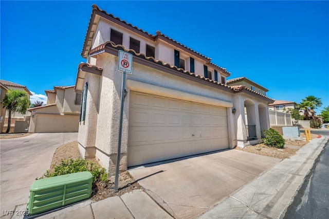9165 Starling Wing Pl, Las Vegas, NV 89143 - mediterranean / spanish-style home featuring concrete driveway, stucco siding, and a tile roof