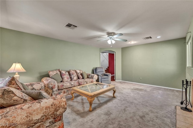 9165 Starling Wing Pl, Las Vegas, NV 89143 - living room with arched walkways, ceiling fan, baseboards, and carpet floors