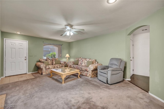 9165 Starling Wing Pl, Las Vegas, NV 89143 - living room featuring arched walkways, a ceiling fan, carpet flooring, and baseboards