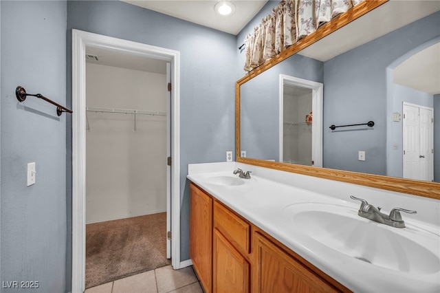 9165 Starling Wing Pl, Las Vegas, NV 89143 - full bath featuring double vanity, tile patterned flooring, and a walk in closet