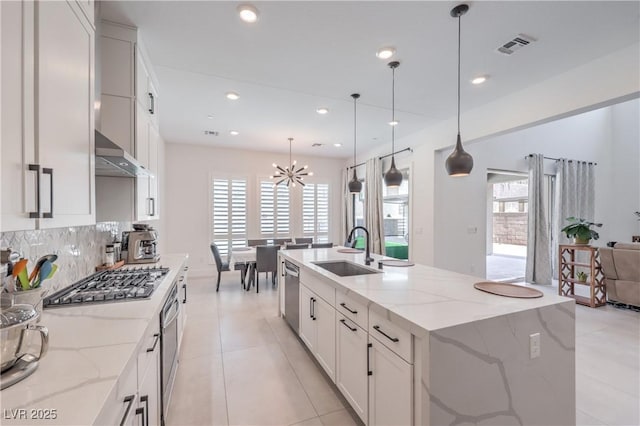 201 Carmel Sky St, Las Vegas, NV 89138 - kitchen with appliances with stainless steel finishes, a chandelier, tasteful backsplash, white cabinetry, and light stone counters