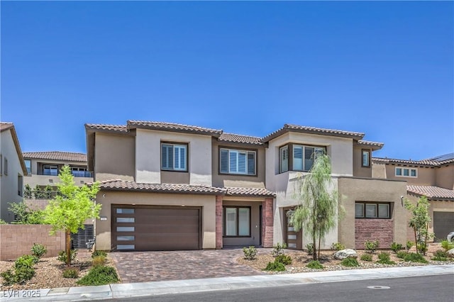 201 Carmel Sky St, Las Vegas, NV 89138 - view of front of home with a garage, stucco siding, a tiled roof, and decorative driveway