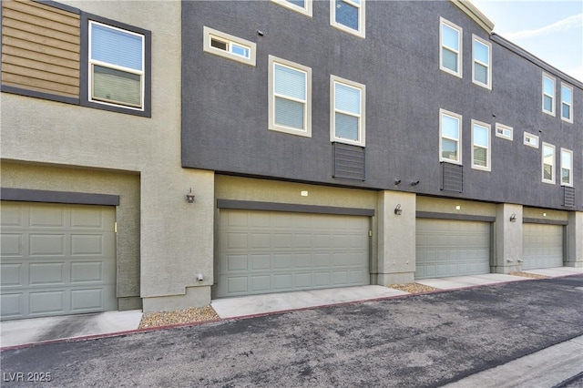 view of front of property with an attached garage and stucco siding