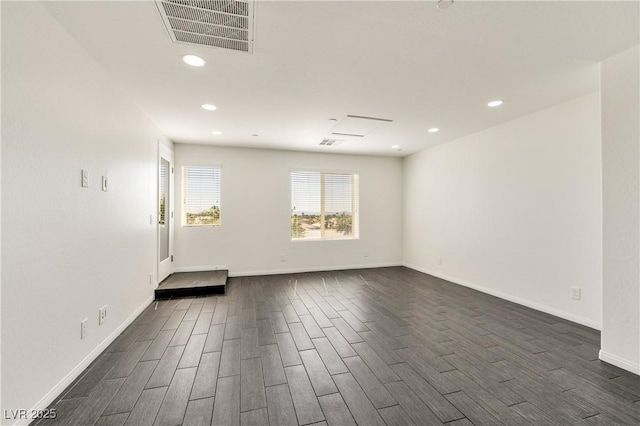 spare room with dark wood finished floors, baseboards, and recessed lighting