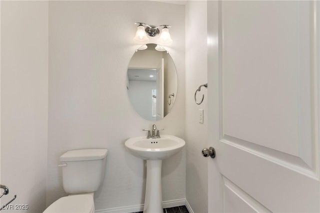 bathroom with toilet and a sink