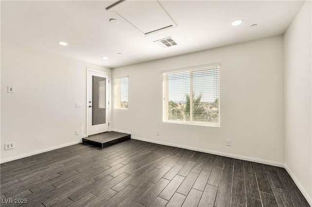 unfurnished room featuring dark wood finished floors, baseboards, and recessed lighting