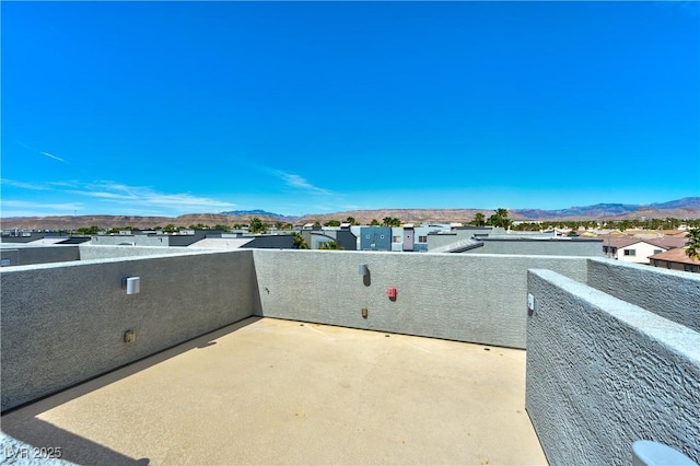 view of patio / terrace featuring a balcony, a mountain view, and a residential view