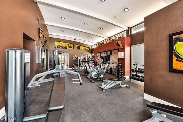 exercise room with lofted ceiling and recessed lighting