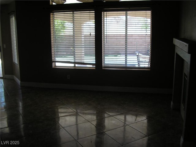 1927 Raspberry Hill Rd, Las Vegas, NV 89142 - empty room featuring dark tile patterned floors and baseboards