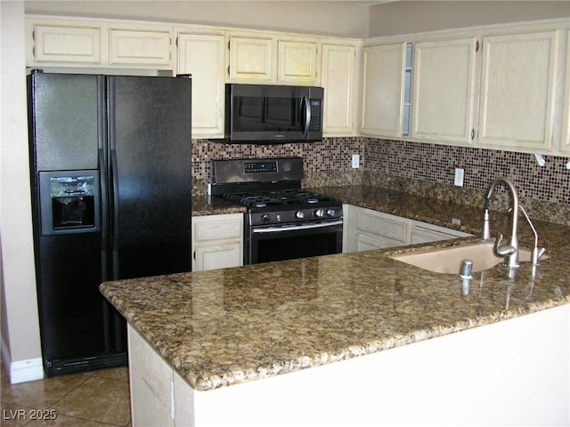 1927 Raspberry Hill Rd, Las Vegas, NV 89142 - kitchen with stainless steel range with gas stovetop, black refrigerator with ice dispenser, a sink, and dark stone countertops