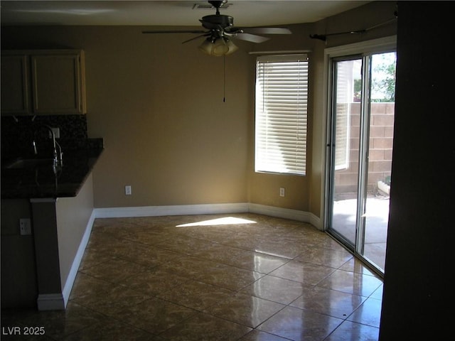 1927 Raspberry Hill Rd, Las Vegas, NV 89142 - unfurnished dining area with a sink, a ceiling fan, and baseboards