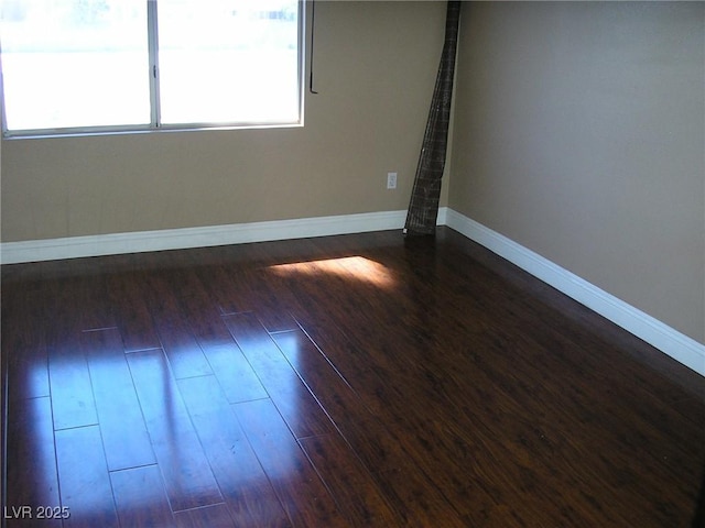 1927 Raspberry Hill Rd, Las Vegas, NV 89142 - unfurnished room featuring dark wood-style floors and baseboards