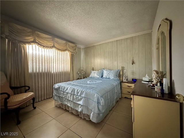 2300 Pardee Pl, Las Vegas, NV 89104 - bedroom with light tile patterned floors, a textured ceiling, and wooden walls