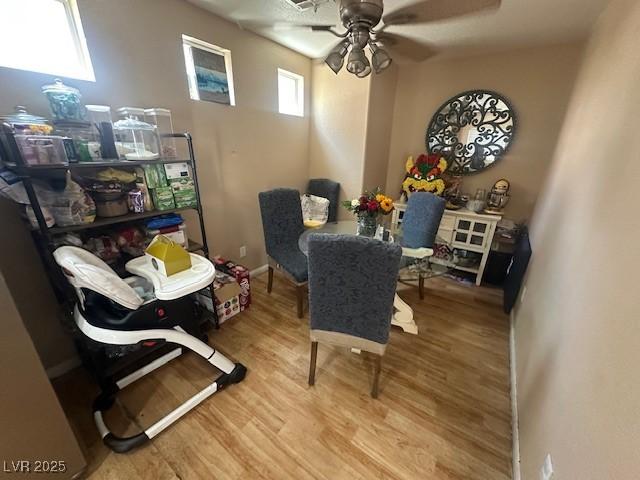 dining room featuring wood finished floors and ceiling fan