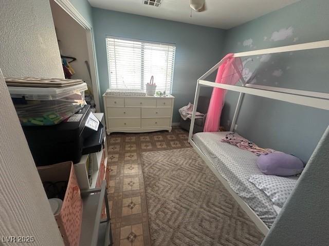 bedroom with tile patterned floors and ceiling fan