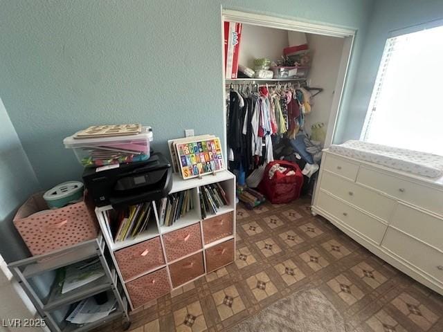 bedroom with a closet and tile patterned floors