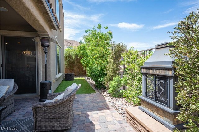 3698 Regatta Landing Dr, Las Vegas, NV 89141 - view of patio with a fireplace