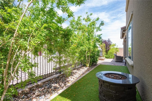 3698 Regatta Landing Dr, Las Vegas, NV 89141 - fenced backyard featuring a patio and a fire pit
