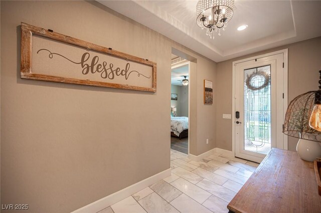 3698 Regatta Landing Dr, Las Vegas, NV 89141 - entrance foyer with a chandelier, baseboards, light marble finish flooring, and a raised ceiling