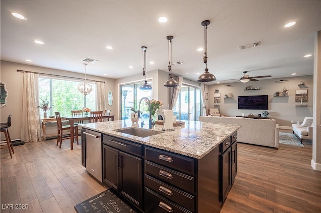 3698 Regatta Landing Dr, Las Vegas, NV 89141 - kitchen with a sink, a ceiling fan, light wood-style flooring, light stone countertops, and recessed lighting