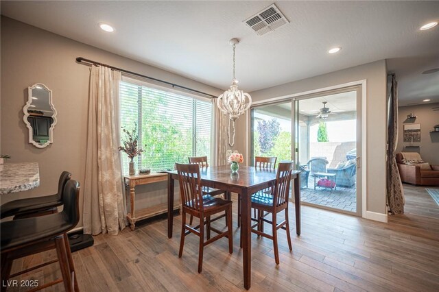3698 Regatta Landing Dr, Las Vegas, NV 89141 - dining area with healthy amount of natural light, wood finished floors, recessed lighting, a chandelier, and a ceiling fan
