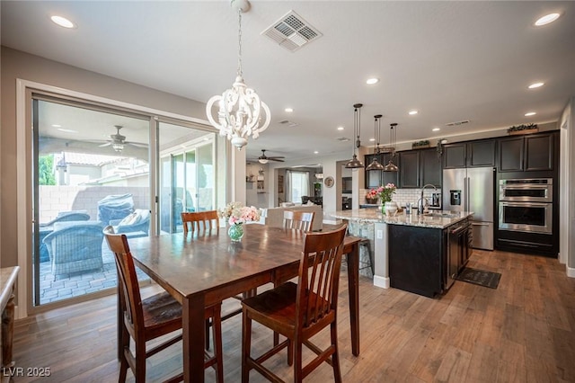 3698 Regatta Landing Dr, Las Vegas, NV 89141 - dining space with ceiling fan, light wood finished floors, recessed lighting, and a chandelier
