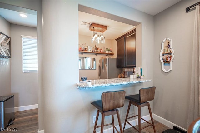 3698 Regatta Landing Dr, Las Vegas, NV 89141 - bar area with freestanding refrigerator, dark wood finished floors, and baseboards