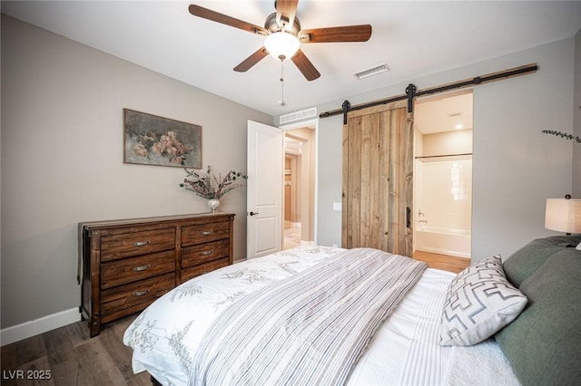 3698 Regatta Landing Dr, Las Vegas, NV 89141 - bedroom featuring a barn door, wood finished floors, baseboards, ceiling fan, and ensuite bathroom