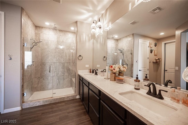 3698 Regatta Landing Dr, Las Vegas, NV 89141 - bathroom with a stall shower, double vanity, baseboards, wood finished floors, and recessed lighting