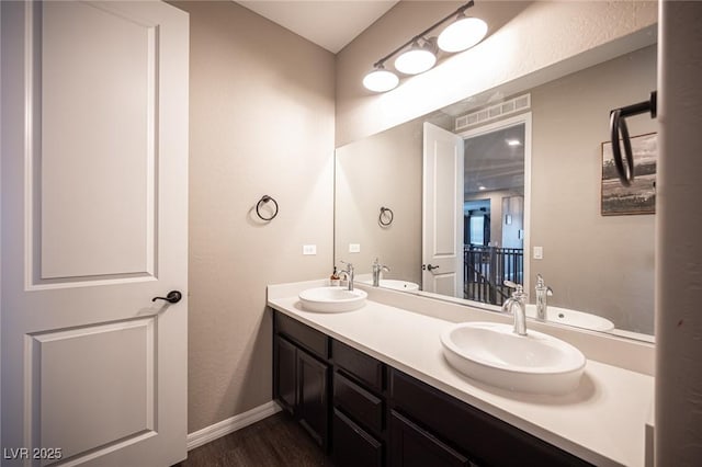 3698 Regatta Landing Dr, Las Vegas, NV 89141 - full bath with wood finished floors, double vanity, and baseboards